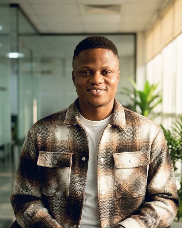 Israel Ibok, founder and lead engineer of Xpectra Systems, smiling in an office
